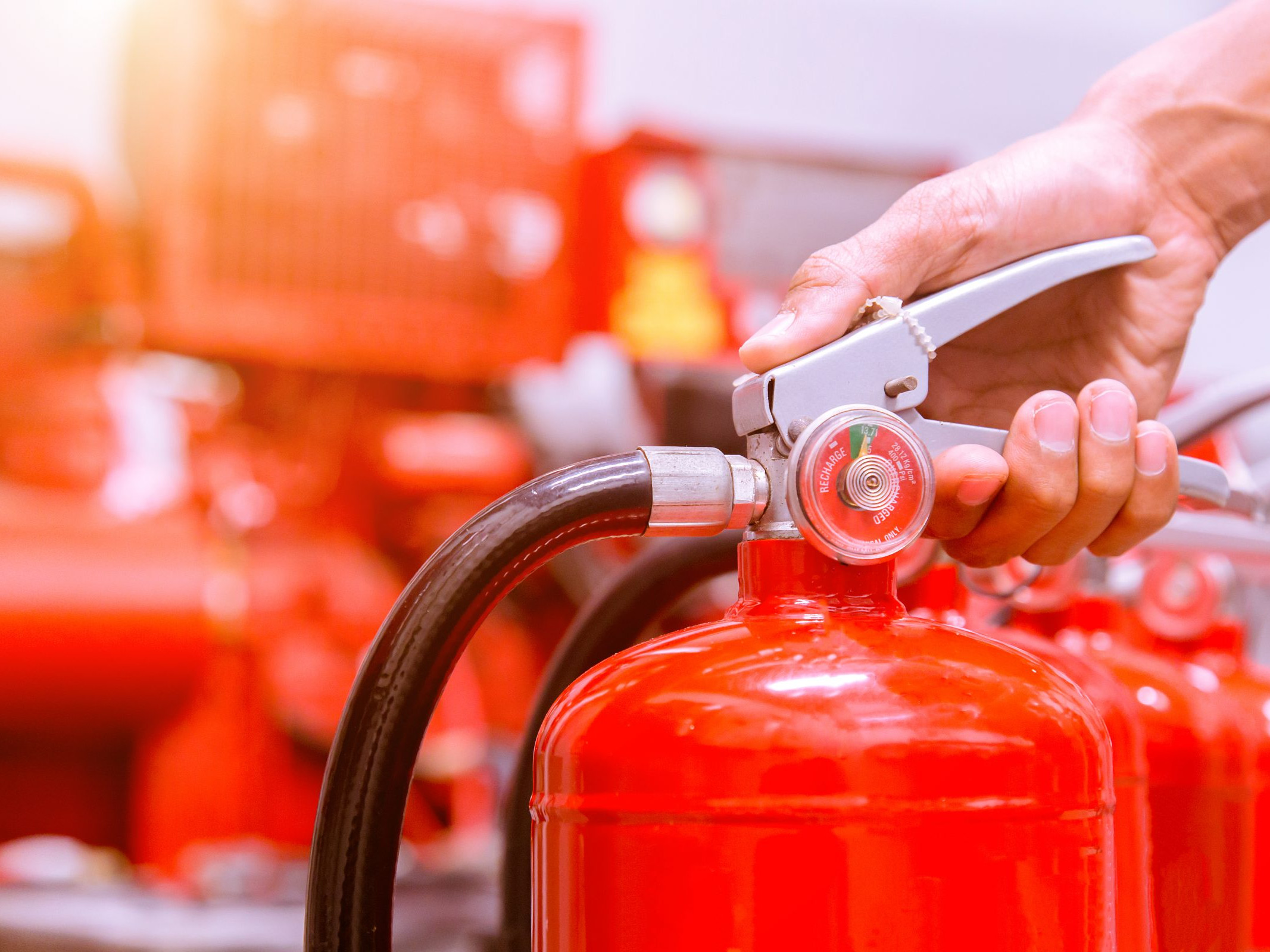 Close up Fire extinguisher and pulling pin on red tank.