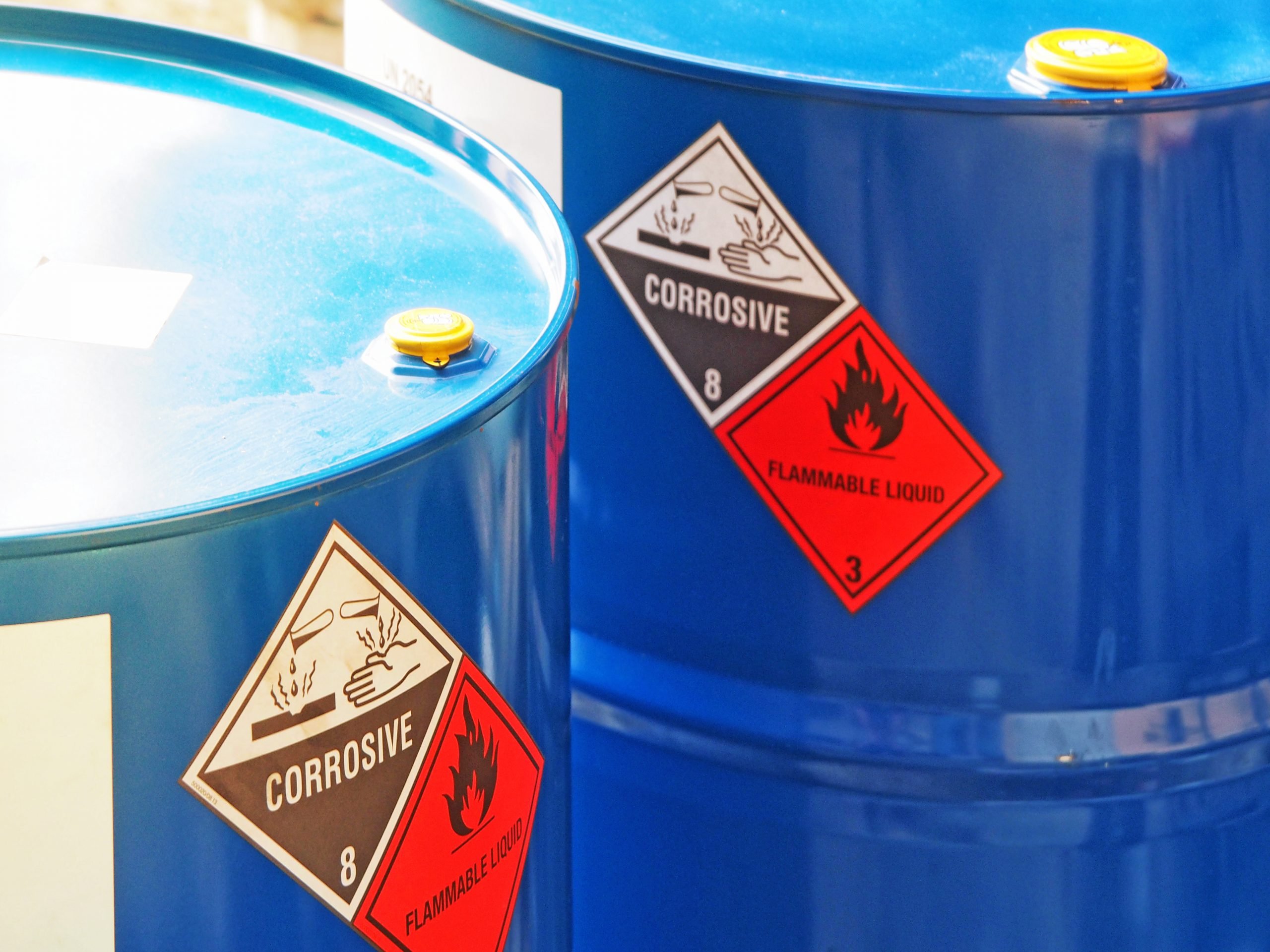 hazardous dangerous chemical barrels ,have warning labels of corrosive & flammable liquid