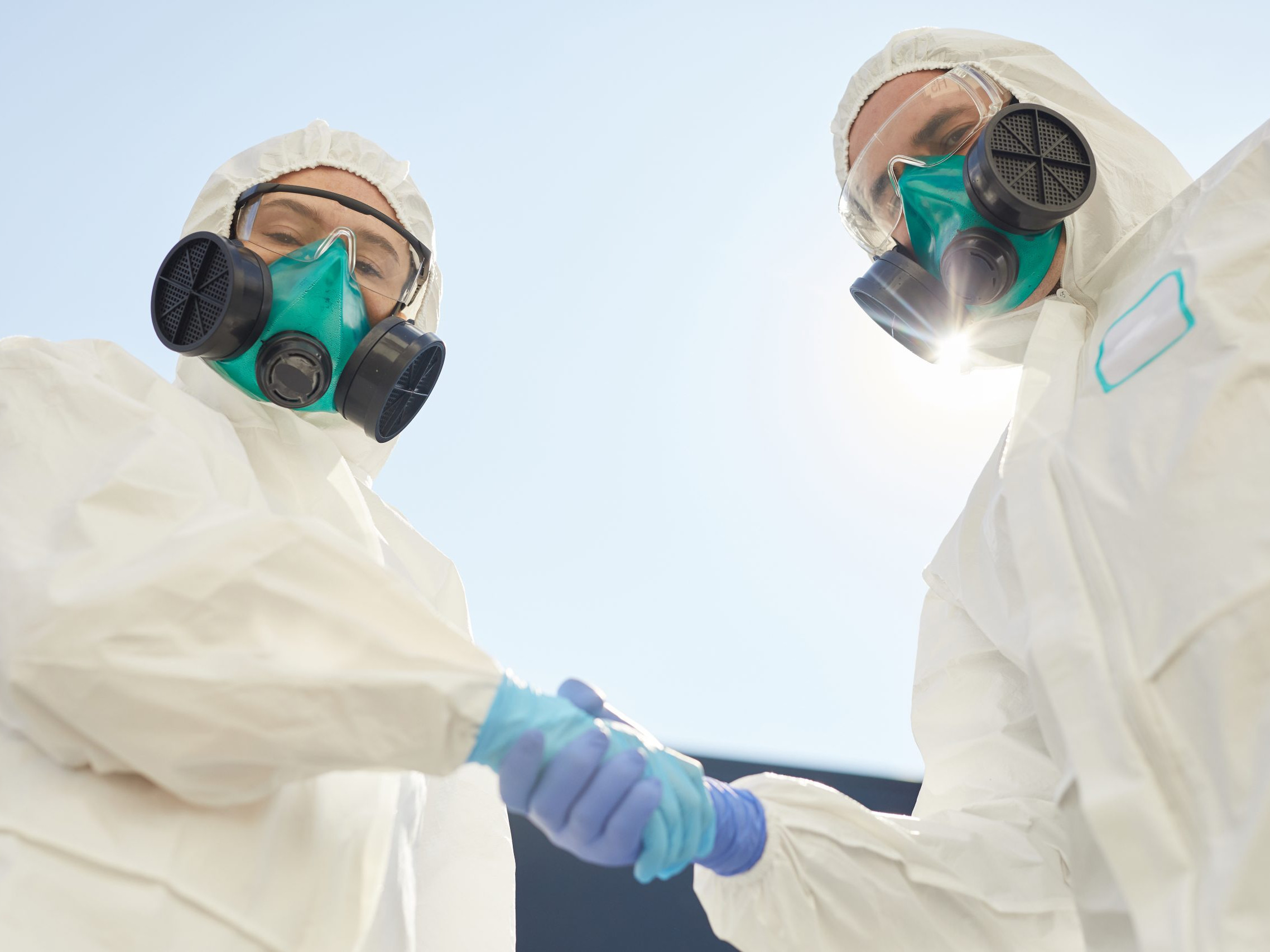 Two Disinfection Workers Shaking Hands
