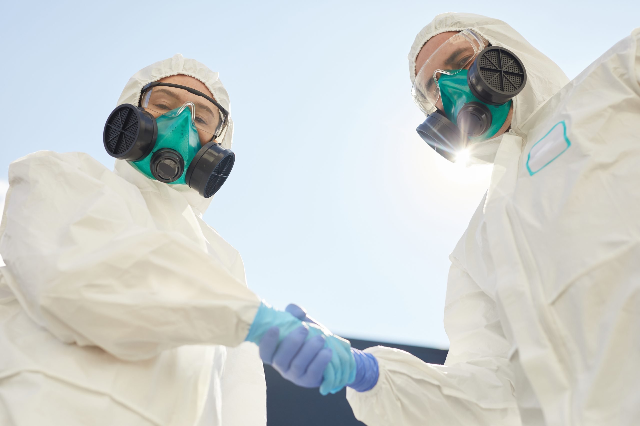Two Disinfection Workers Shaking Hands